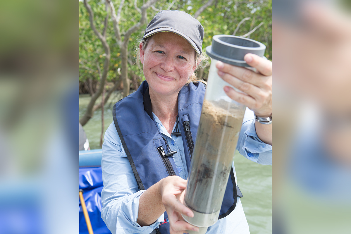 Dr Julia Fortune with a sediment core withdrawn from a Top End tidal creek.