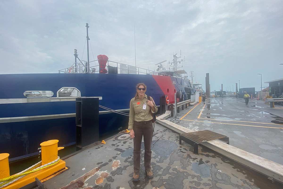 Community engagement ranger Natasha Hoffmann, in front of an Australian Border Force Ship (Photo sourced by an ABF officer).