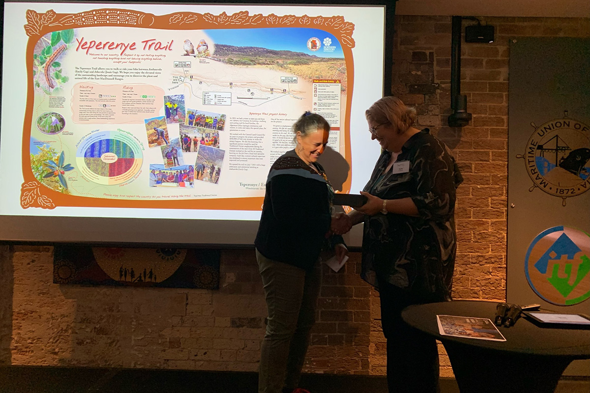 Park Interpretation Officer Rebecca Duncum accepting the award on behalf of Parks and Wildlife, Traditional Owners and Graphic Designer Pauline Clack.