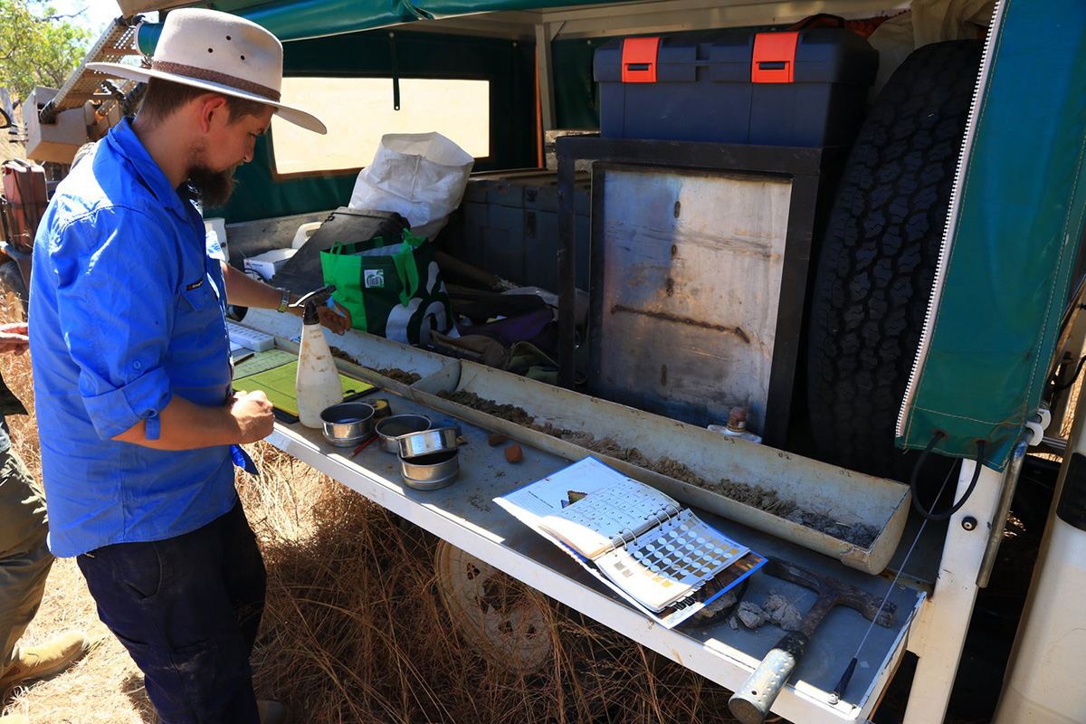 Soil samples are taken using a drill rig and the core is laid out for analysis and classification.