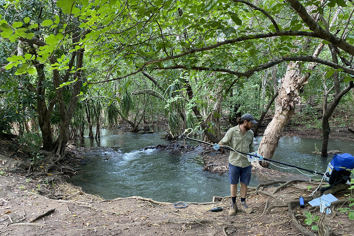 Xavier Tingle and Kien Nguyen collecting and analysing water samples in the Adelaide River Catchment.